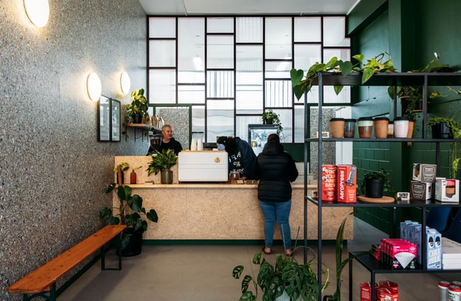 A customer ordering at a cafe counter inside Mr Clifton's Gisborne.