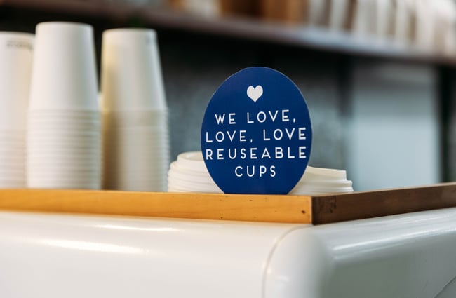 A sign that says 'we love love reusable cups'.
