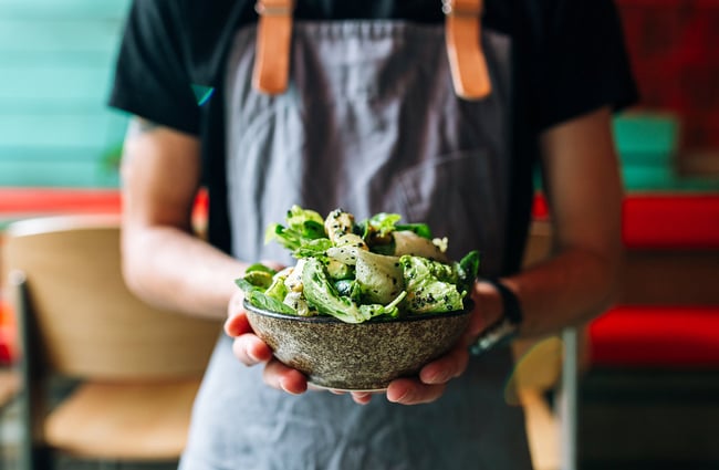 Person Holding a salad.