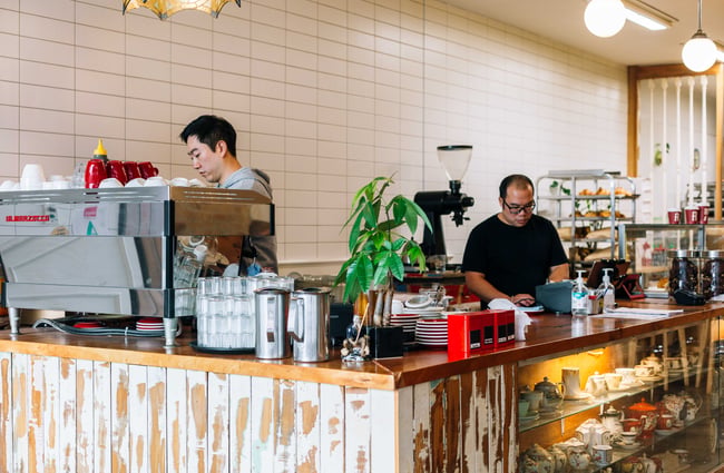 Two men working behind the counter at Mr T's Baked Goods and Eatery, Auckland.