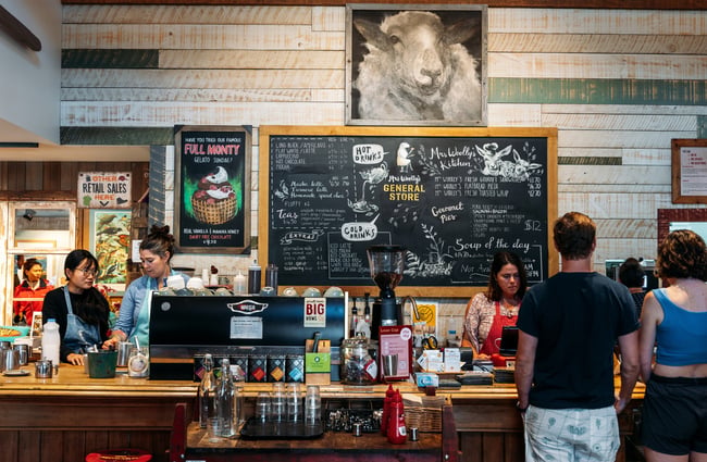 A staff member being served at a cafe counter.