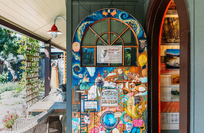 A mural on wall at the entrance to Mrs Woolly's in Glenorchy.