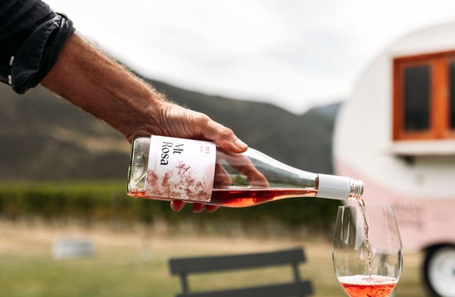 A glass of rose being poured into a glass.