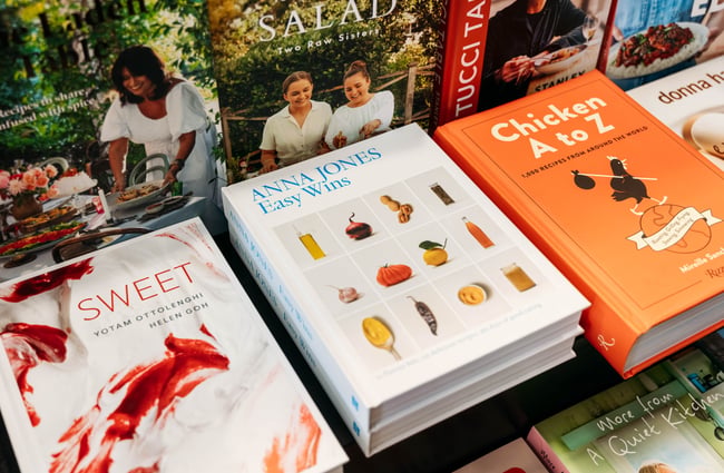 A close up of cookbooks on a table.
