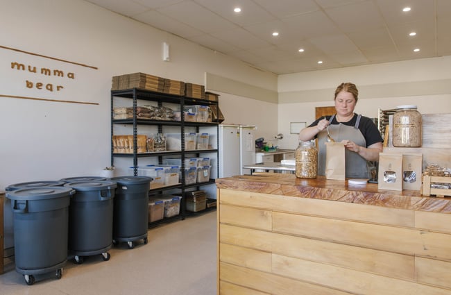 Shop assistant adding products into packaging in Mumma Bear.