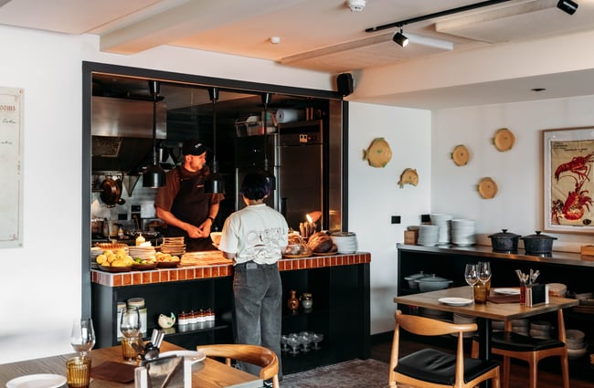 View into the kitchen where two staff members are working at Muttonbird, Wānaka.