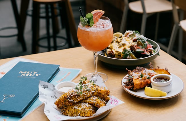 Tacos, corn, nachos and cocktail on table at Muy Muy in Christchurch