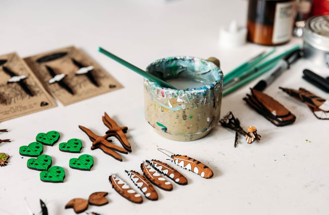 A close up of painted wooden jewellery.