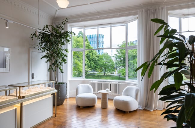 Two sofas are situated in the bay window next to a jewellery cabinet at Naveya & Sloane Jewellery.