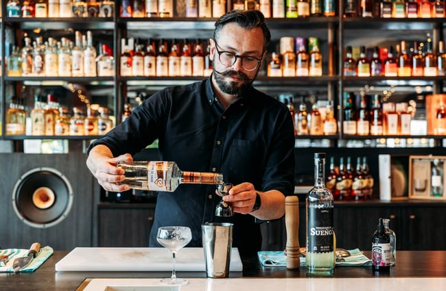Bartender making a cocktail at the bar at Neat at Made.