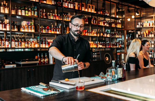 Bartender pouring a drink at Neat at Made.