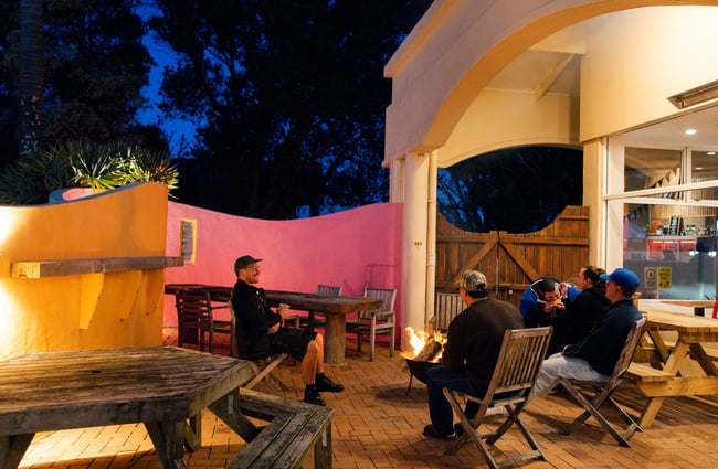 Customers sit around an outdoor fire pit at Neighbourhood Cantina.