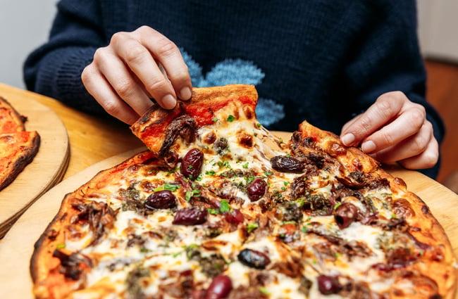A close up of a large pizza on a table.