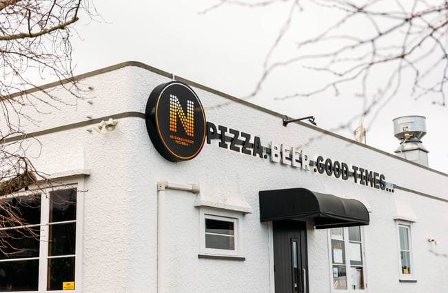 The white exterior of Neighbourhood Pizzeria Gisborne.