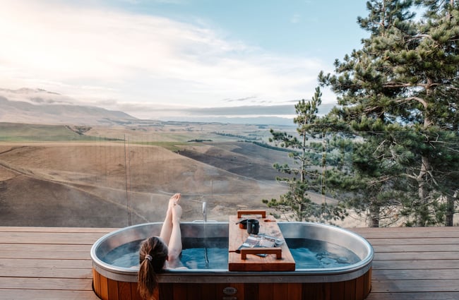 A woman in an outdoor bath tub.
