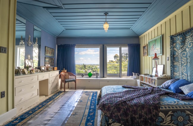 A bright blue and cream bedroom setting.