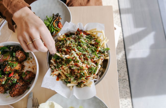 Eating loaded fries at Niche Cafe and Eatery in Sumner.