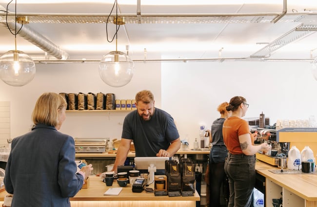 Man standing at the till at Niche Cafe and Eatery in Sumner.