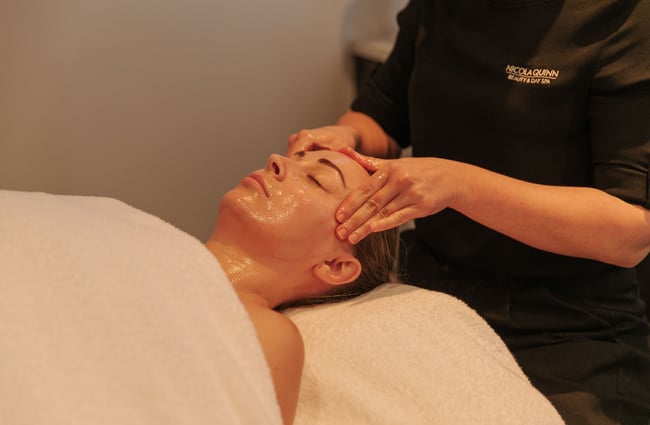A woman receiving a face massage.
