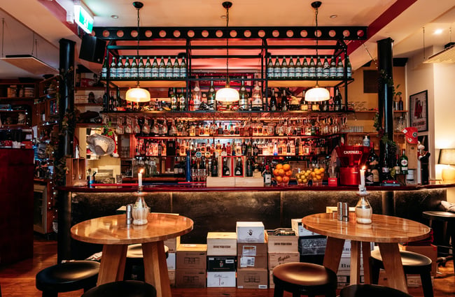 Bar area with shelves of alcohol at Nicolini's.