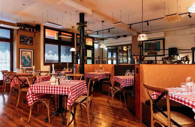 Red and white tablecloths on the tables in the dining room at Nicolini's.