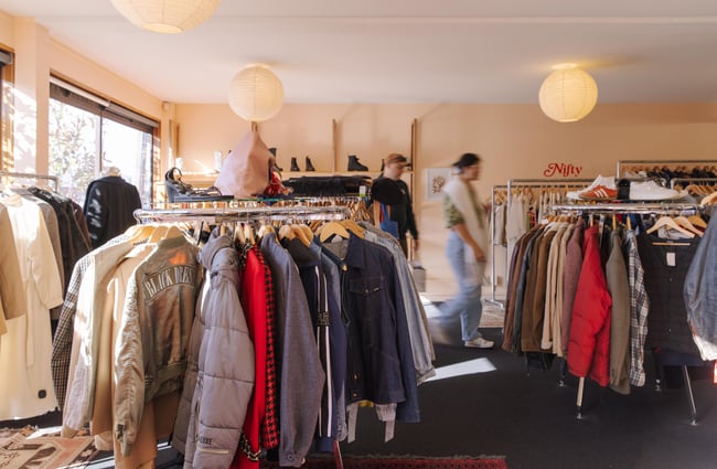Racks of clothing and customers in Nifty.