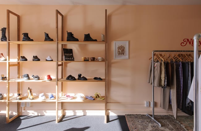 Rack of shoes and accessories against the wall at Nifty.