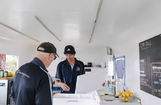 Two men working in the kitchen at Nin's Bin.