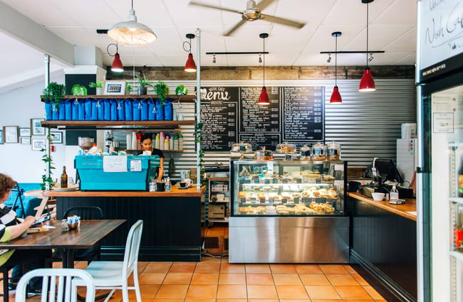 View of coffee machine and menu on the wall.