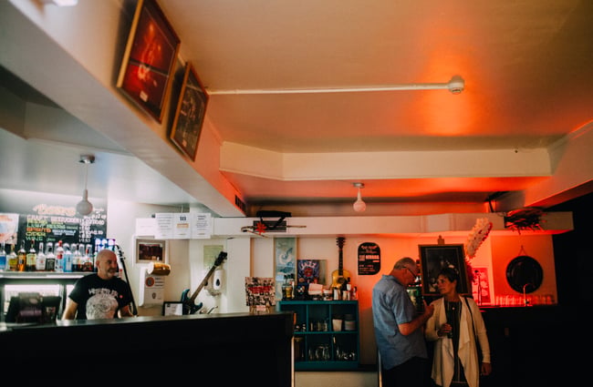 Two customers wait by the bar.