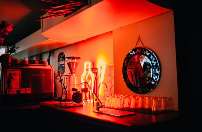 Red light decorations shines on drinks.
