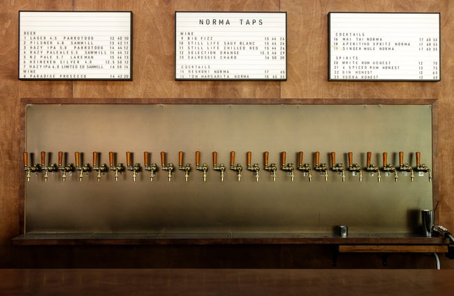 The beer taps lined up along a wall at Norma Taps Auckland.