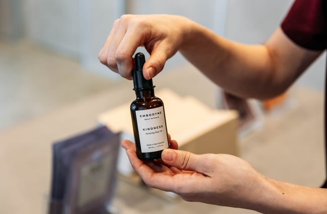 A close up of body oil in a jar.