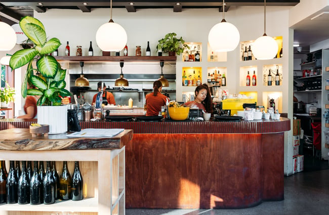 Staff members working behind a bar.