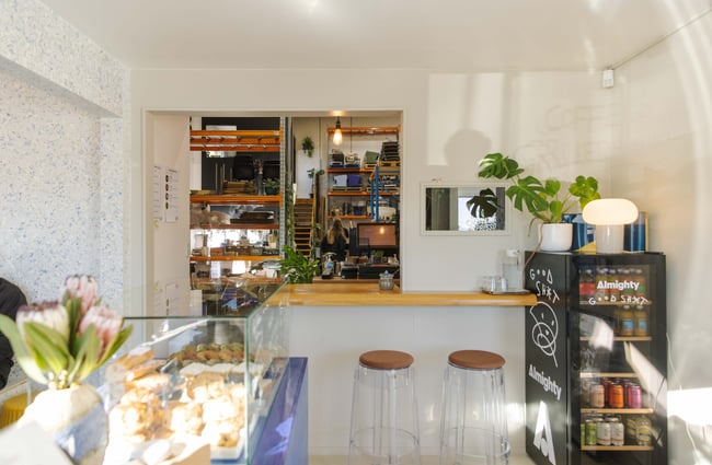 Interior space view through the window, including the cabinet and seating area at Odds Coffee.