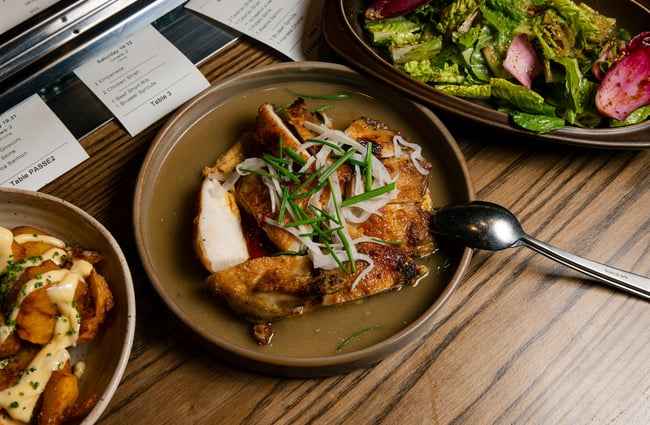 A flatlay of several plates of food on the table at Odeon.