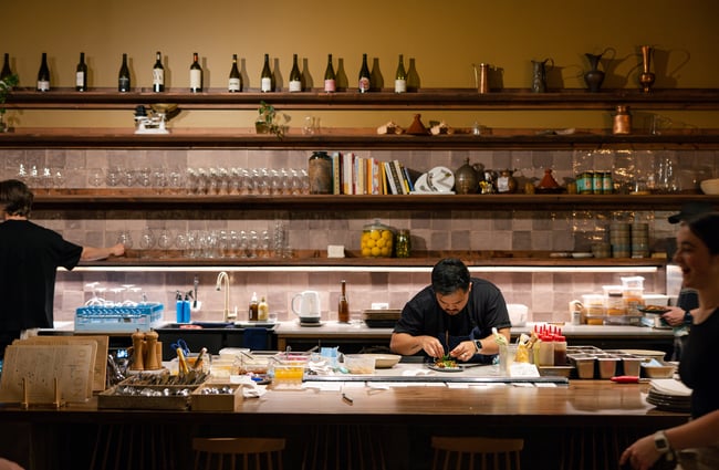 Open kitchen at Odeon with a view of the chef preparing meals.