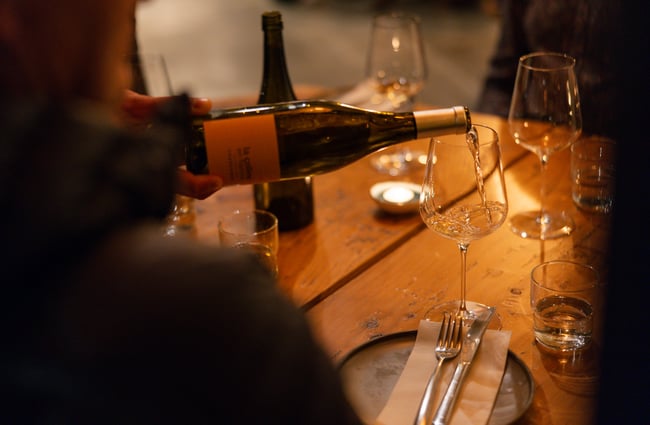 Glass of wine being poured by staff member at Odeon.