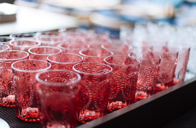 Close up of pink water glasses.