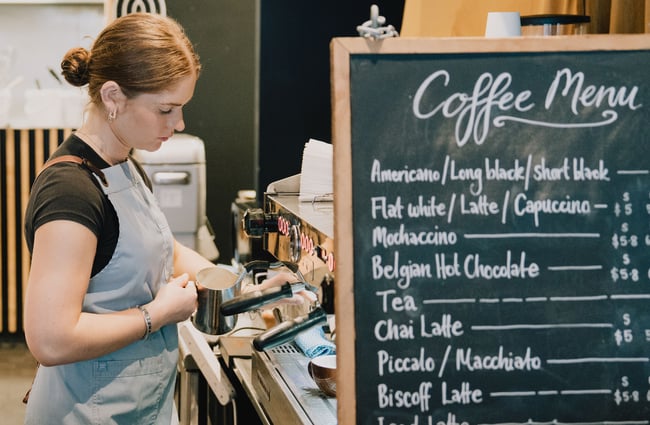 A barista making coffee.