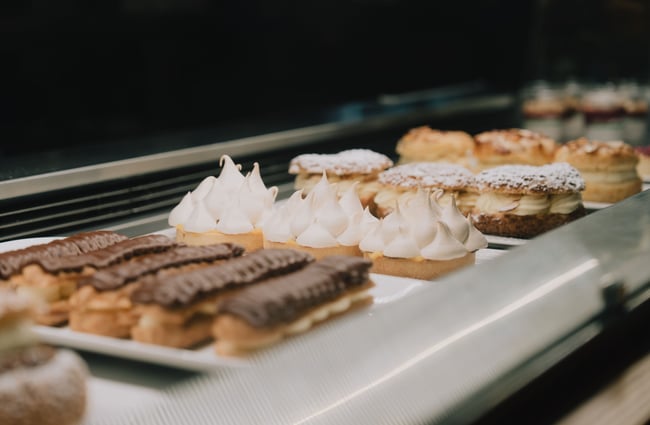 Pastries in a glass cabinet.