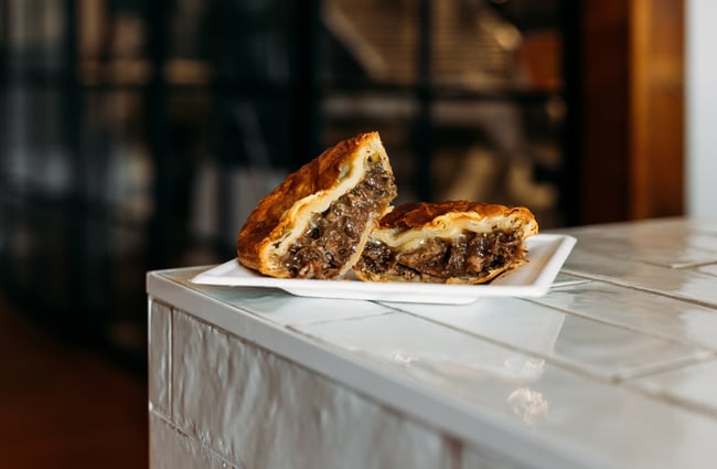 A close up of a meat pie cut in half.