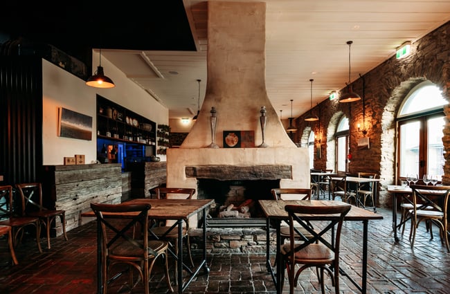 A fireplace and seating area inside Olivers Clyde.