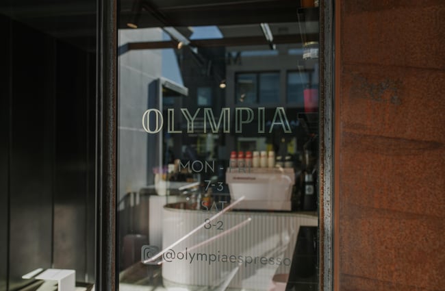 The 'Olympia' sign on a glass door.
