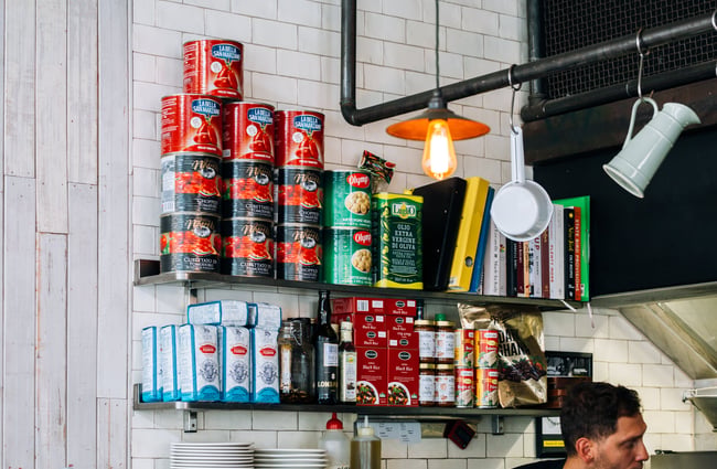Cans and jars on a shelf.