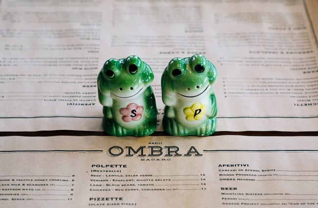 Close up of salt and pepper on a table.