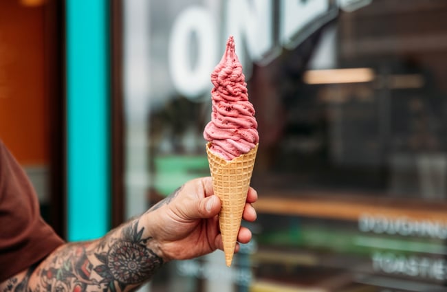 A hand holding an ice cream.
