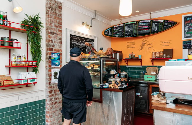 A man ordering at a cafe counter.