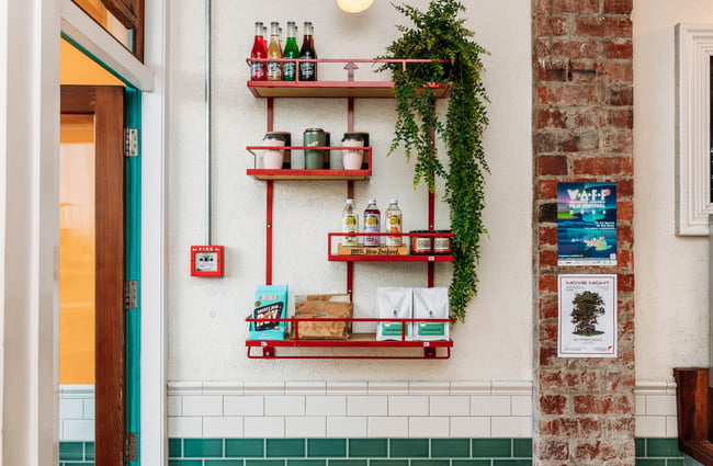 Items on display on shelves inside a cafe.