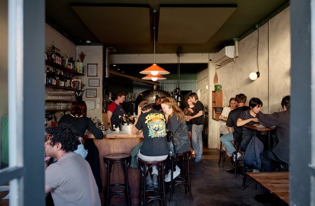 Looking through the doorway into a busy dining room at OOH-FA in Auckland